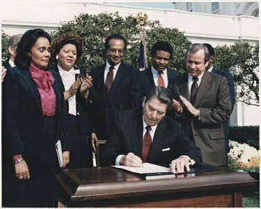 751px-Photograph_of_President_Reagan_and_the_Signing_Ceremony_for_Martin_Luther_King_Holiday_Legislation