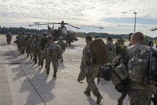 soldiers walking towards helicopter