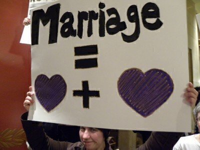 Woman holding a pro same-sex marriage sign above her head