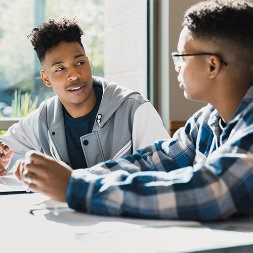 students-talking-at-table.png