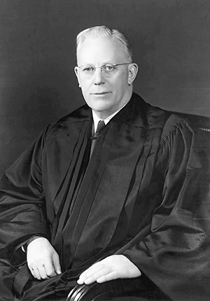 Earl Warren, three-quarters seated portrait wearing judicial robes, by Harris and Ewing,
photography.