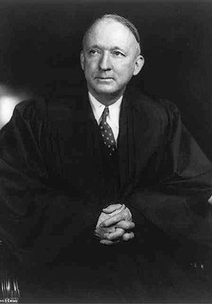 Hugo Black, three-quarter seated portrait, wearing judicial robes.