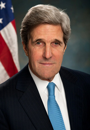 John Kerry, head-and-shoulders portrait in front of U.S. flag, 2013.