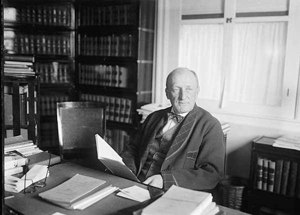 Justice J.C. McReynolds of Supreme Court, seated at desk with papers and books in front of him, 1924.