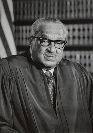 Portrait photograph of Chief Justice Thurgood Marshall, wearing judicial robe, seated, facing front.