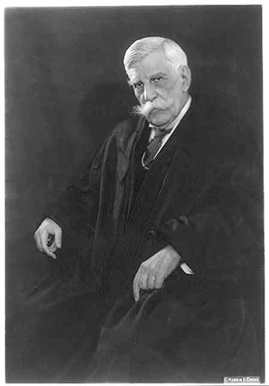 Oliver Wendell Holmes, three-quarters seated portrait, in judicial robes. Photo by Harris & Ewing, 1930.