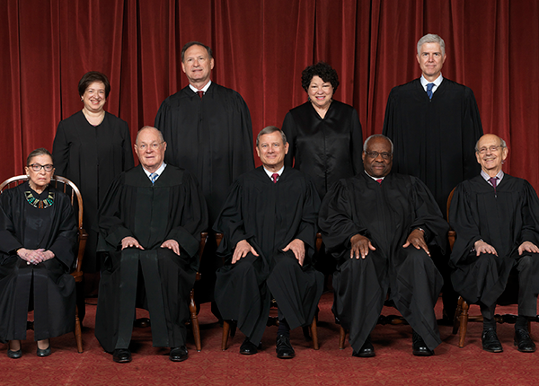 The nine justices of the Supreme Court of the United States in April 2017, wearing judicial robes. Seated (front) from left to right: Justices Ruth Bader Ginsburg and Anthony M. Kennedy, Chief Justice John G. Roberts, Jr., and Justices Clarence Thomas and Stephen G. Breyer. Standing (rear), from left to right: Justices Elena Kagan, Samuel A. Alito, Sonia Sotomayor, and Neil M. Gorsuch.